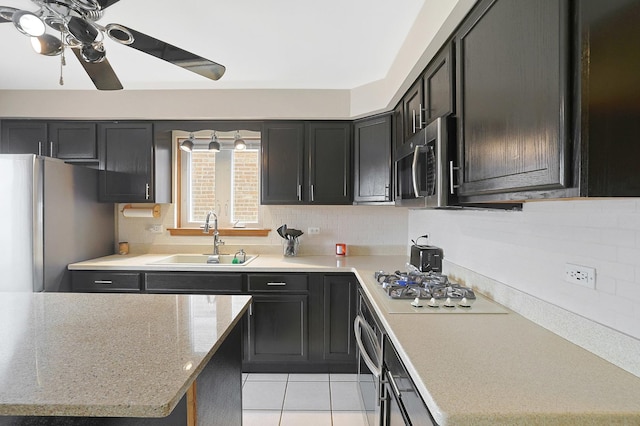 5531 S Mcvicker Ave, Chicago, IL 60638 - kitchen with stainless steel appliances, a sink, tasteful backsplash, and ceiling fan