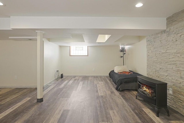 5531 S Mcvicker Ave, Chicago, IL 60638 - below grade area featuring wood finished floors, a wood stove, and baseboards