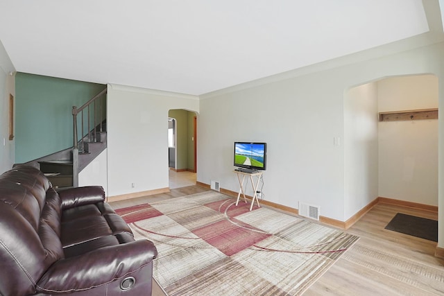 5531 S Mcvicker Ave, Chicago, IL 60638 - living area featuring arched walkways, light wood finished floors, stairs, and baseboards