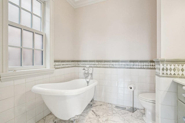 3926 N Greenview Ave, Chicago, IL 60613 - bathroom with a freestanding tub, tile walls, crown molding, wainscoting, and marble finish floors