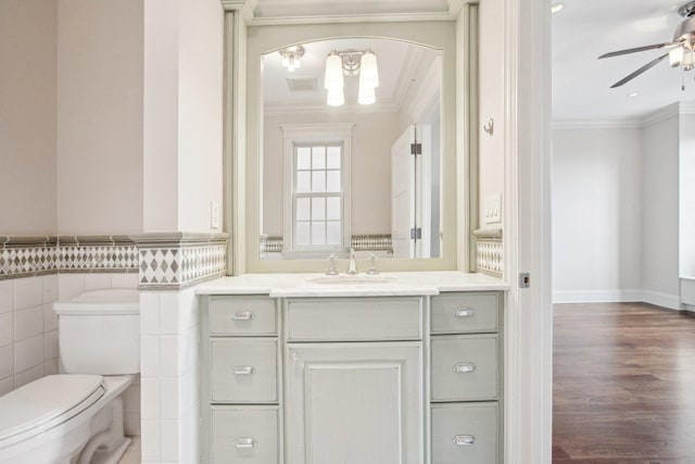 3926 N Greenview Ave, Chicago, IL 60613 - bathroom featuring crown molding, a ceiling fan, vanity, tile walls, and toilet
