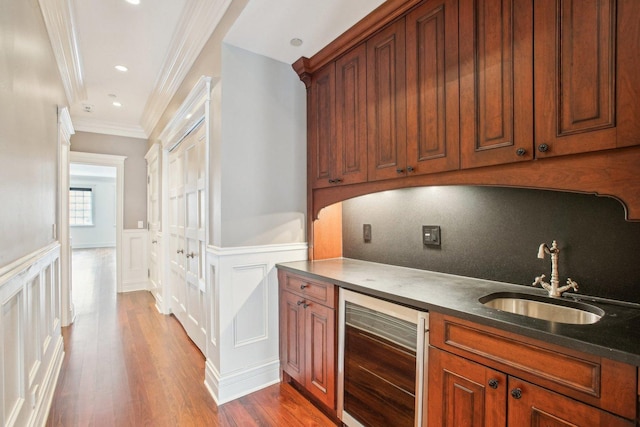 3926 N Greenview Ave, Chicago, IL 60613 - bar featuring beverage cooler, a sink, a decorative wall, crown molding, and wood finished floors