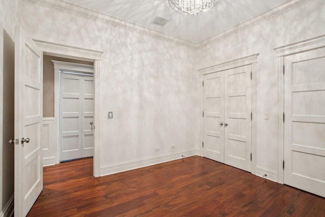 3926 N Greenview Ave, Chicago, IL 60613 - unfurnished bedroom with wood finished floors, a closet, ornamental molding, and a chandelier