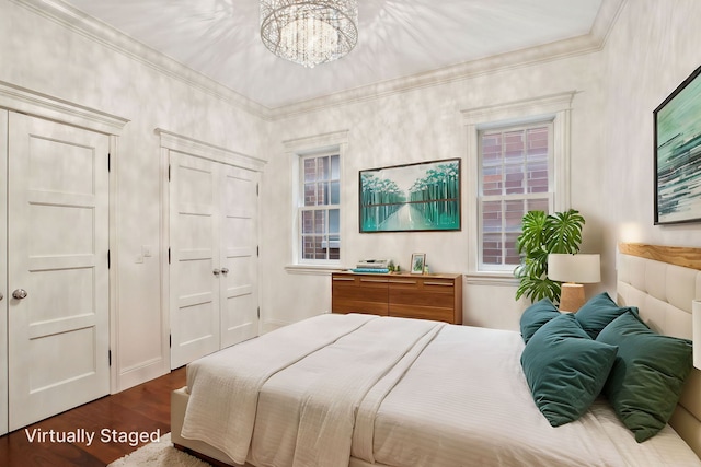 3926 N Greenview Ave, Chicago, IL 60613 - bedroom with dark wood-style flooring, a chandelier, ornamental molding, and a closet
