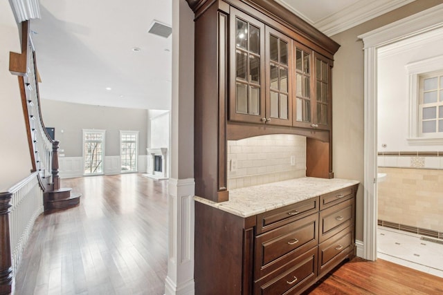 3926 N Greenview Ave, Chicago, IL 60613 - kitchen with a wainscoted wall, wood finished floors, glass insert cabinets, light stone countertops, and open floor plan