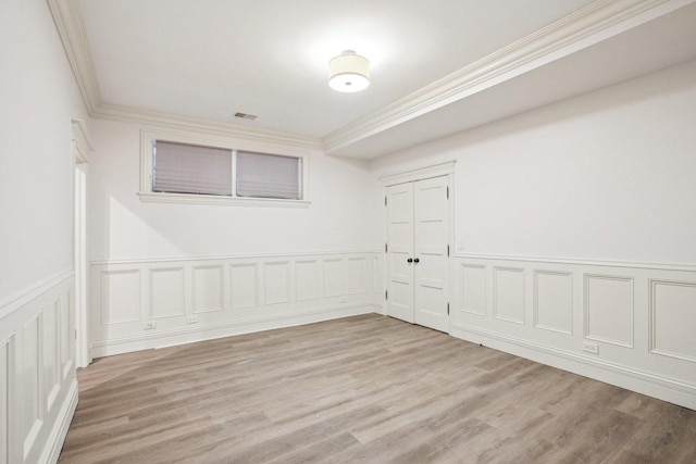 3926 N Greenview Ave, Chicago, IL 60613 - empty room featuring crown molding, wood finished floors, wainscoting, and a decorative wall