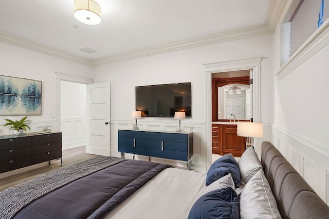 3926 N Greenview Ave, Chicago, IL 60613 - bedroom with crown molding, a decorative wall, wainscoting, light wood finished floors, and a sink