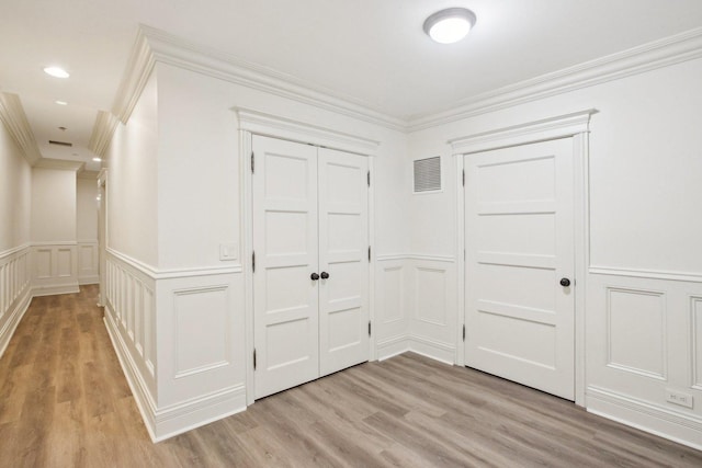 3926 N Greenview Ave, Chicago, IL 60613 - hall featuring a decorative wall, crown molding, light wood-style floors, and wainscoting