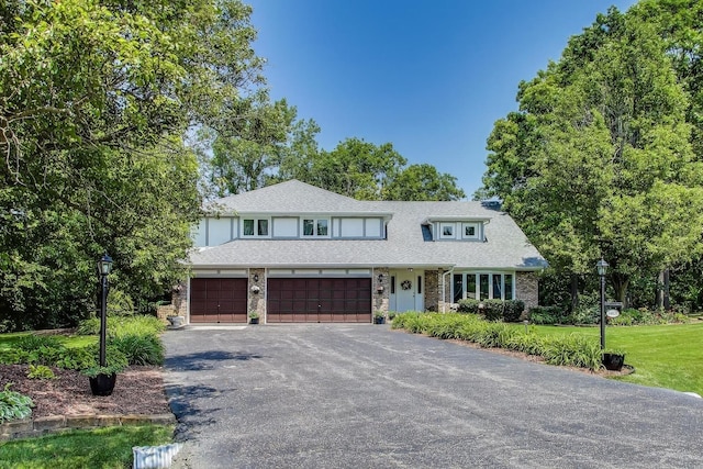 14828 W N Creek Ct, Homer Glen, IL 60491 - view of front of home with asphalt driveway, stone siding, a front yard, and an attached garage