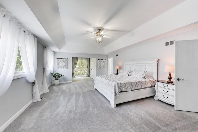 14828 W N Creek Ct, Homer Glen, IL 60491 - bedroom with carpet, a tray ceiling, access to outside, and ceiling fan