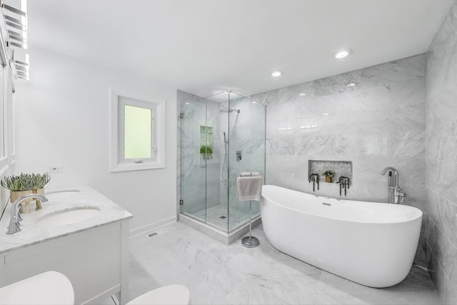 14828 W N Creek Ct, Homer Glen, IL 60491 - bathroom featuring marble tiled flooring, a marble finish shower, a freestanding tub, tile walls, and recessed lighting