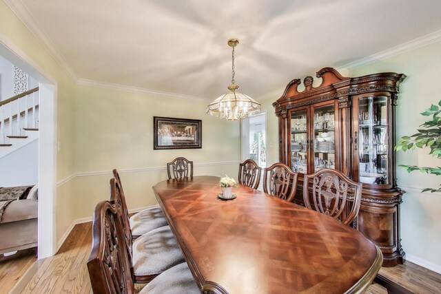 14828 W N Creek Ct, Homer Glen, IL 60491 - dining area with wood finished floors, a chandelier, stairway, and ornamental molding