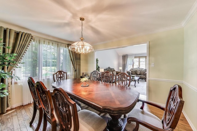14828 W N Creek Ct, Homer Glen, IL 60491 - dining space featuring a chandelier, light wood finished floors, and crown molding