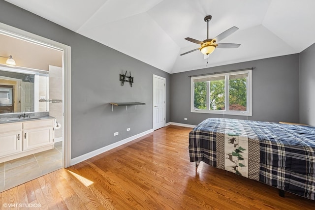 4332 Camelot Cir, Naperville, IL 60564 - bedroom featuring vaulted ceiling, light wood finished floors, a sink, ensuite bath, and a ceiling fan