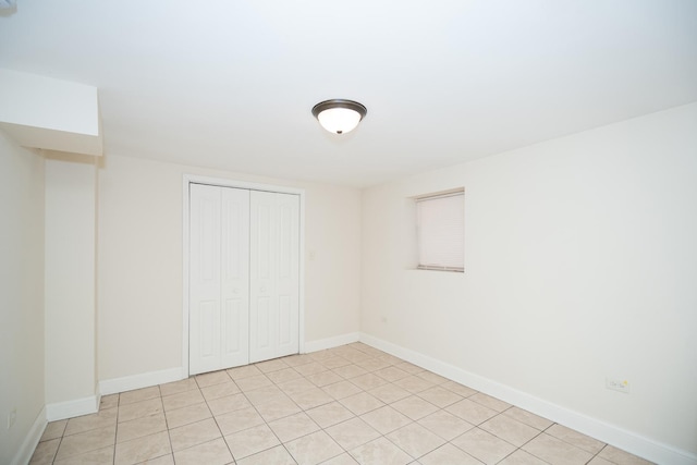 2440 Oak Park Ave, Berwyn, IL 60402 - unfurnished bedroom with a closet, baseboards, and light tile patterned flooring