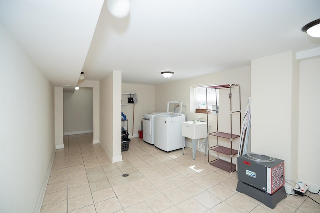2440 Oak Park Ave, Berwyn, IL 60402 - laundry area featuring separate washer and dryer, light tile patterned floors, a sink, and baseboards