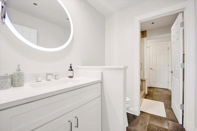 616 W Fulton St Unit 212, Chicago, IL 60661 - full bathroom featuring vanity, toilet, a shower stall, stone finish floors, and baseboards