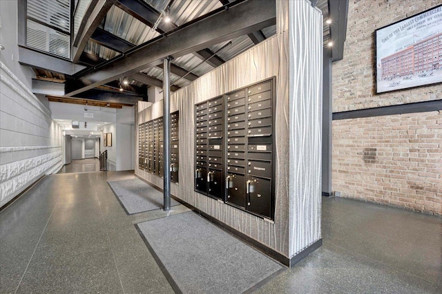 616 W Fulton St Unit 212, Chicago, IL 60661 - view of property's community with mail area, brick wall, and beamed ceiling