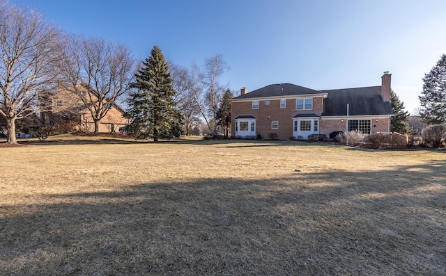 10N872 Williamsburg Dr, Elgin, IL 60124 - back of house featuring a chimney and a yard