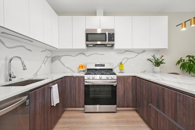 2342 W Adams St Unit 304, Chicago, IL 60612 - kitchen with appliances with stainless steel finishes, a sink, white cabinets, and modern cabinets