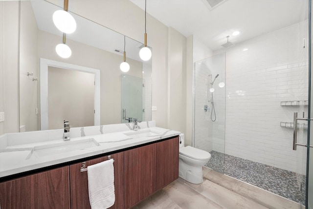 2342 W Adams St Unit 304, Chicago, IL 60612 - bathroom with a tile shower, double vanity, and toilet