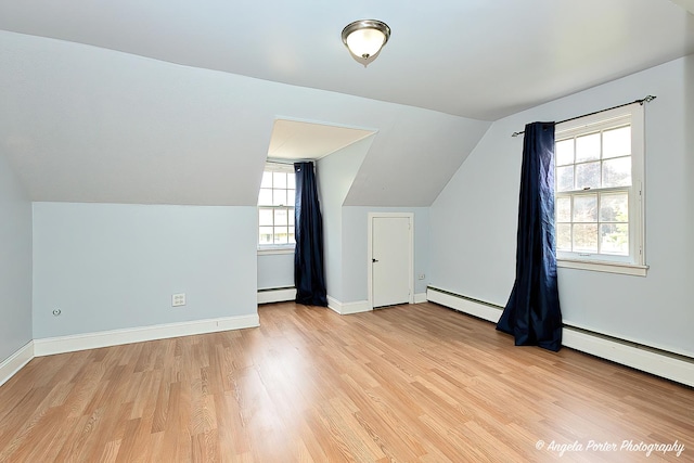 617 Colville Pl, Waukegan, IL 60087 - additional living space featuring baseboard heating, light wood finished floors, lofted ceiling, and baseboards