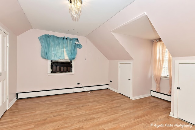 617 Colville Pl, Waukegan, IL 60087 - additional living space with baseboard heating, lofted ceiling, wood finished floors, and baseboards