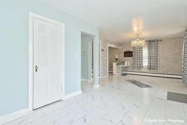 617 Colville Pl, Waukegan, IL 60087 - unfurnished living room featuring a baseboard heating unit, a chandelier, baseboards, and marble finish floors