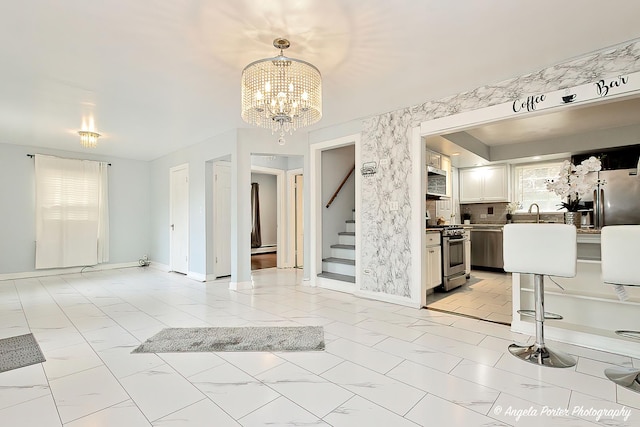 617 Colville Pl, Waukegan, IL 60087 - interior space featuring stairway, a chandelier, light marble finish floors, and baseboards