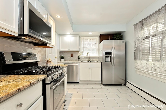 617 Colville Pl, Waukegan, IL 60087 - kitchen featuring appliances with stainless steel finishes, baseboard heating, a sink, white cabinets, and recessed lighting