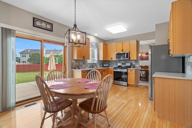 32526 Pilgrims Ct, Lakemoor, IL 60051 - dining room featuring light wood-type flooring and a chandelier