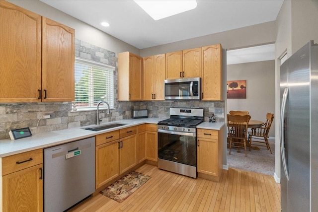 32526 Pilgrims Ct, Lakemoor, IL 60051 - kitchen with stainless steel appliances, a sink, light wood-style flooring, and light countertops