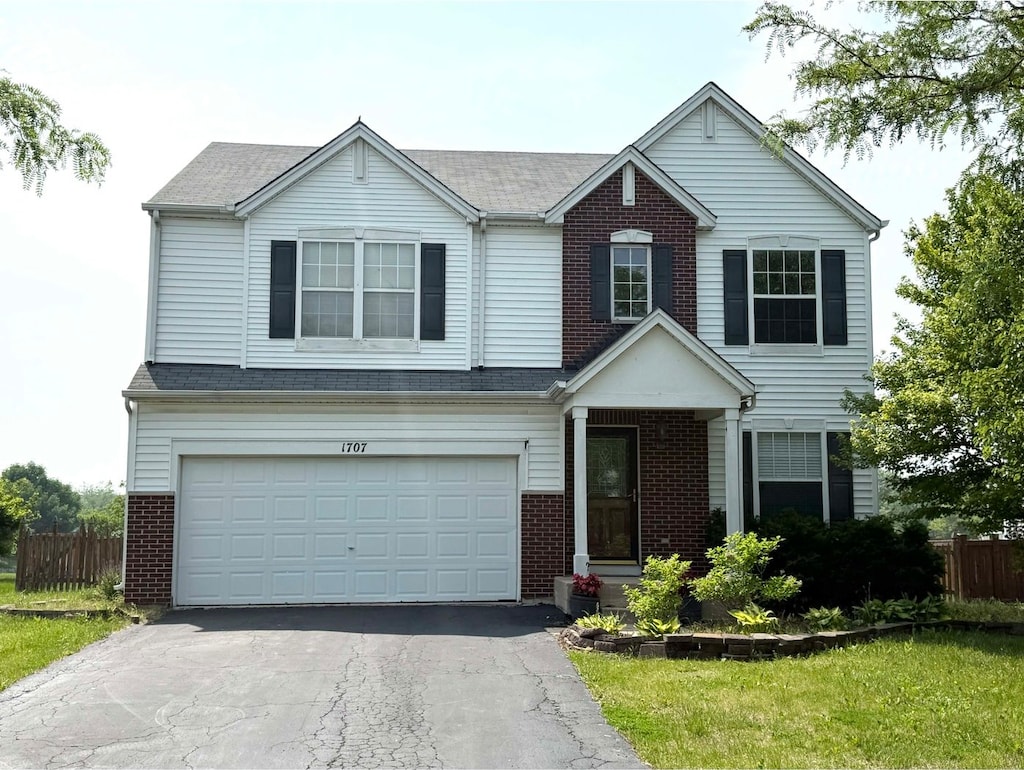 1707 Cascade Ridge Dr, Plainfield, IL 60586 - traditional-style house with brick siding, driveway, and an attached garage