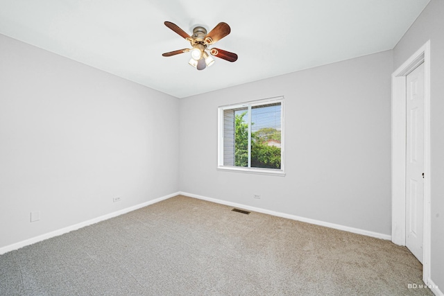 unfurnished bedroom featuring carpet, baseboards, and a ceiling fan