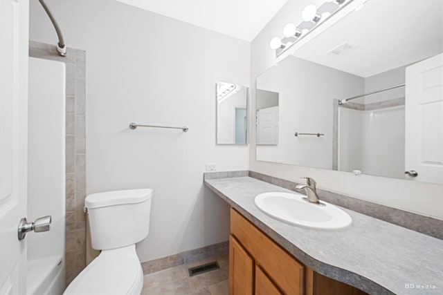 bathroom with vanity, baseboards, toilet, and a shower