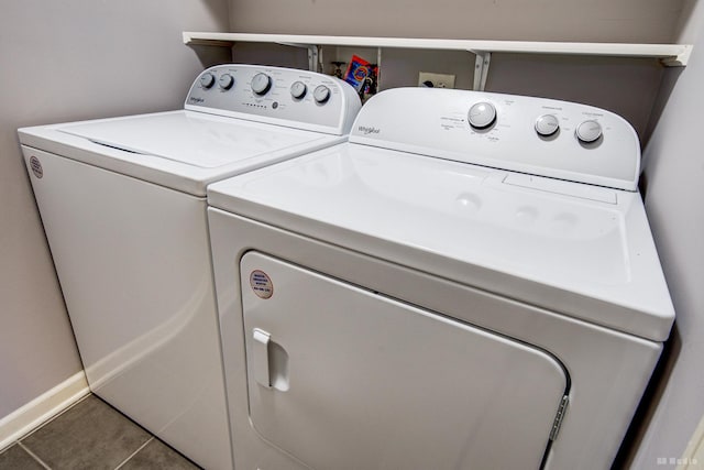 laundry area featuring washer and clothes dryer and tile patterned flooring