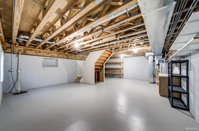 unfinished basement with stairs and heating unit