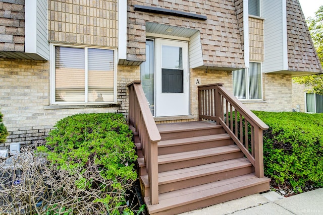 property entrance featuring brick siding