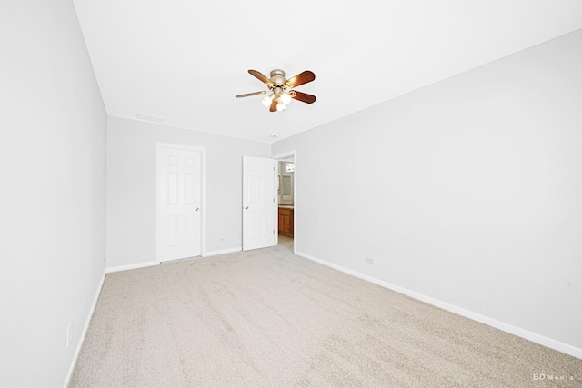 unfurnished bedroom with baseboards, light carpet, and a ceiling fan