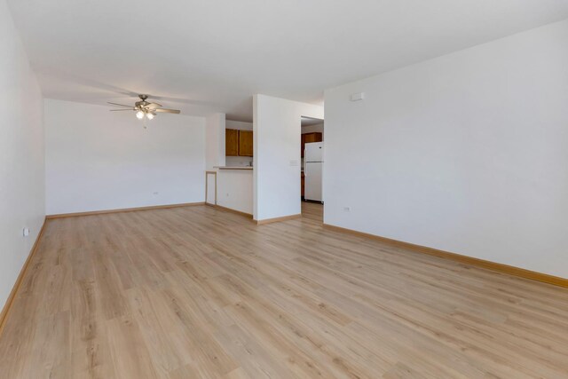 1505 Silverstone Dr Unit 1505, Carpentersville, IL 60110 - unfurnished living room with a ceiling fan, light wood-style floors, and baseboards