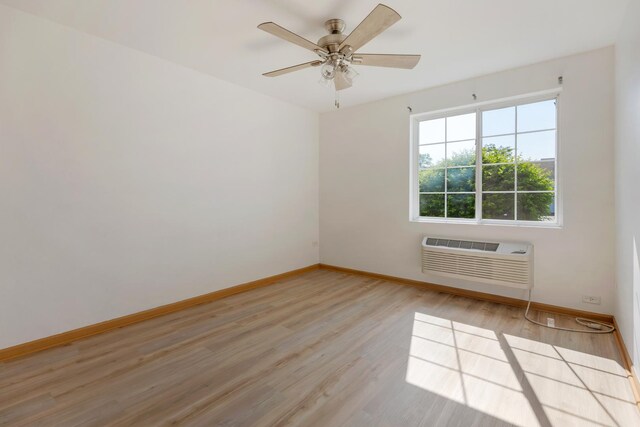 1505 Silverstone Dr Unit 1505, Carpentersville, IL 60110 - empty room with an AC wall unit, baseboards, light wood finished floors, and ceiling fan