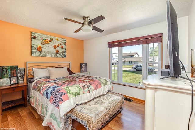 4037 W 90th Pl, Hometown, IL 60456 - bedroom featuring wood finished floors, a textured ceiling, ceiling fan, and baseboards