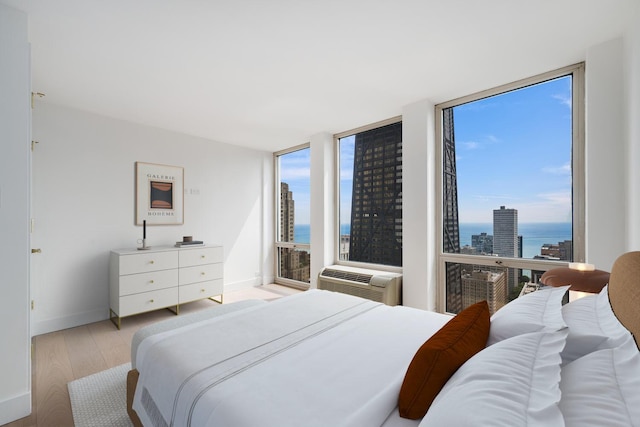 111 E Chestnut St Unit 40C, Chicago, IL 60611 - bedroom featuring light wood-style floors, a water view, and a wall mounted AC