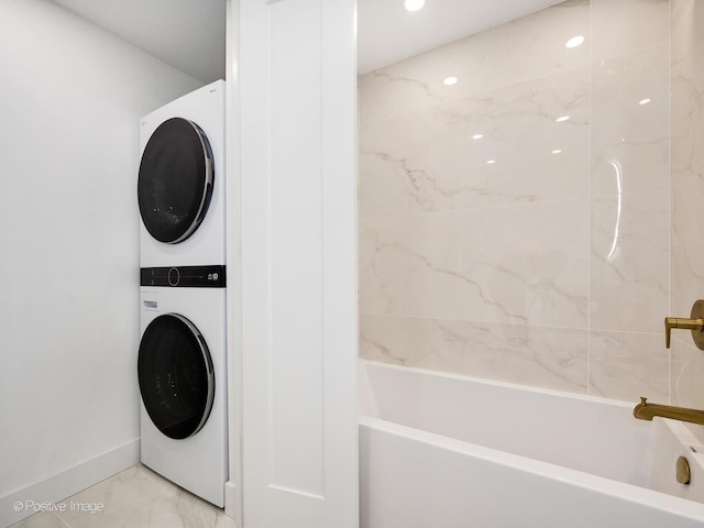 111 E Chestnut St Unit 40C, Chicago, IL 60611 - laundry room with stacked washer and clothes dryer and light marble finish floors