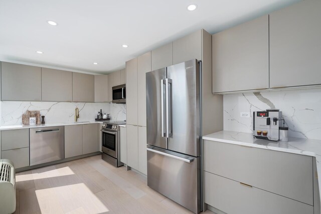 111 E Chestnut St Unit 40C, Chicago, IL 60611 - kitchen featuring stainless steel appliances, gray cabinets, modern cabinets, tasteful backsplash, and recessed lighting