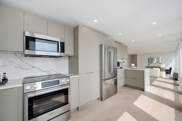 111 E Chestnut St Unit 40C, Chicago, IL 60611 - kitchen featuring stainless steel appliances, gray cabinets, light countertops, and recessed lighting