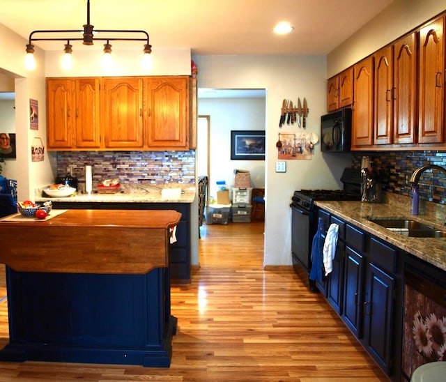 111 Magnolia Ln, Lindenhurst, IL 60046 - kitchen featuring black appliances, a sink, decorative backsplash, light wood-type flooring, and brown cabinets