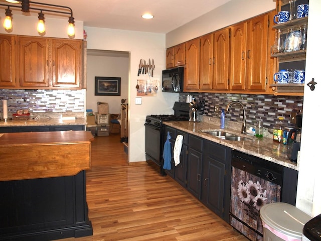 111 Magnolia Ln, Lindenhurst, IL 60046 - kitchen with black appliances, a sink, brown cabinetry, tasteful backsplash, and light wood finished floors