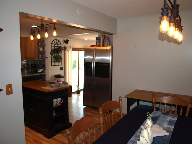 111 Magnolia Ln, Lindenhurst, IL 60046 - kitchen featuring stainless steel fridge with ice dispenser, light wood-style flooring, tasteful backsplash, and brown cabinetry