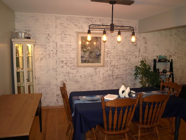 111 Magnolia Ln, Lindenhurst, IL 60046 - dining space with wood finished floors and brick wall